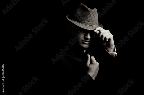 Bas portrait clé du jeune gangster avec le chapeau dans l'obscurité Poster