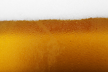 Close-up picture of a beer with foam and bubbles