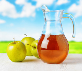 Sticker - Jug of apple juice on nature background