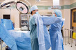© Tyler Olson - Scrub Nurse Putting Sterile Gown on Surgeon