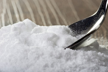 Iron spoon of baking soda close up