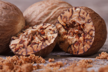 sliced ​​and grated nutmeg on an old wooden table. macro