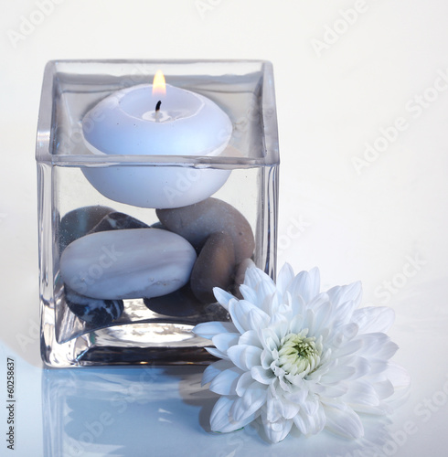 Fototapeta na wymiar Decorative vase with candle, water and stones