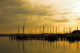 Fototapeta Pomosty - Docked yachts in marina at sunset