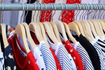 Shop shirts colorful fabric hanging on a rack.