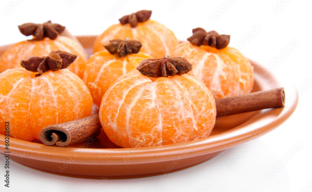Ripe sweet tangerines on color plate, isolated on white