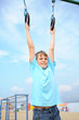 © Pavel Losevsky - A boy engaged in sports rings on the playground