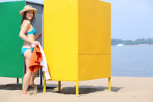 Woman Comes In The Changing Cabin On The Beach