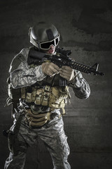 Wall Mural - Soldier with mask aiming a rifle