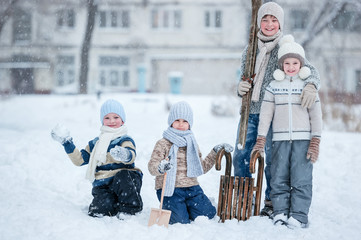 Wall Mural - Children playing in the snow on a winter day