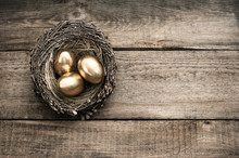 Golden Easter Eggs On Wooden Background