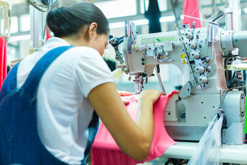 Wall Mural - Indonesian Seamstress in Asian textile factory