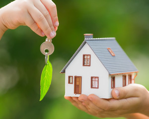 Wall Mural - Ecology house and key in hands