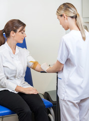 Wall Mural - Nurse Drawing Blood From Businesswoman's Arm