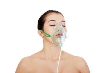 diseased female patient wearing a oxygen mask