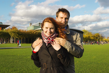 Outdoor happy couple in love, Museum Plein, autumn Amsterdam bac