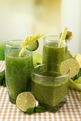 Glasses of green vegetable juice and vegetables