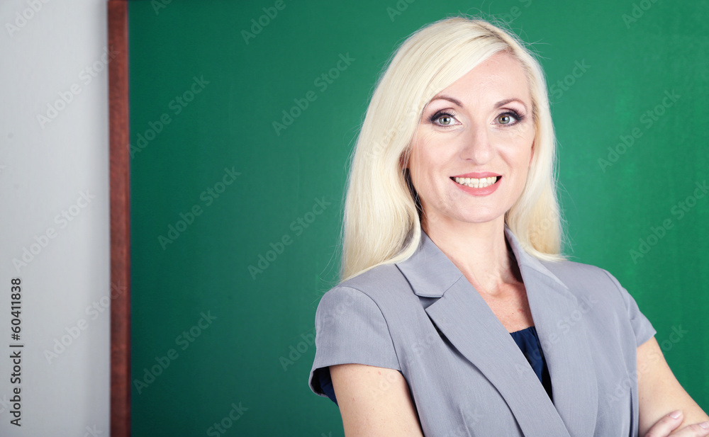 School teacher near blackboard close-up