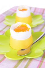 Boiled eggs in egg cups on table close-up