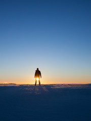 silhouette of man standing in winter landscape