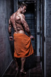 © IgorKireev - Muscular young sexy guy wrapped in a towel