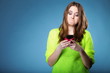 © Voyagerix - Funny girl with mobile phone reads message