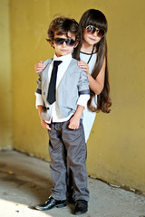 Canvas Print - portrait of stylish little boy and girl outdoors