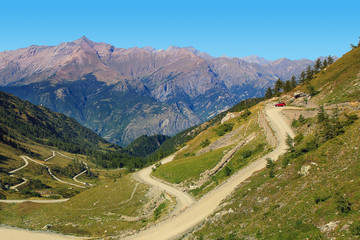 Wall Mural - Unpaved road among mountains.