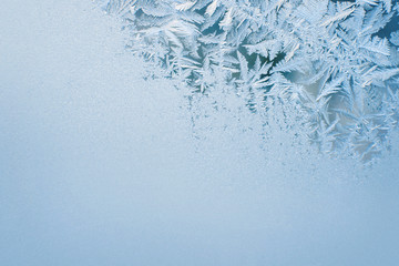 The patterns made by the frost on the window. Frosted glass