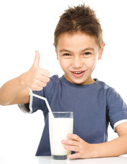 Wall Mural - Cute boy with a glass of milk