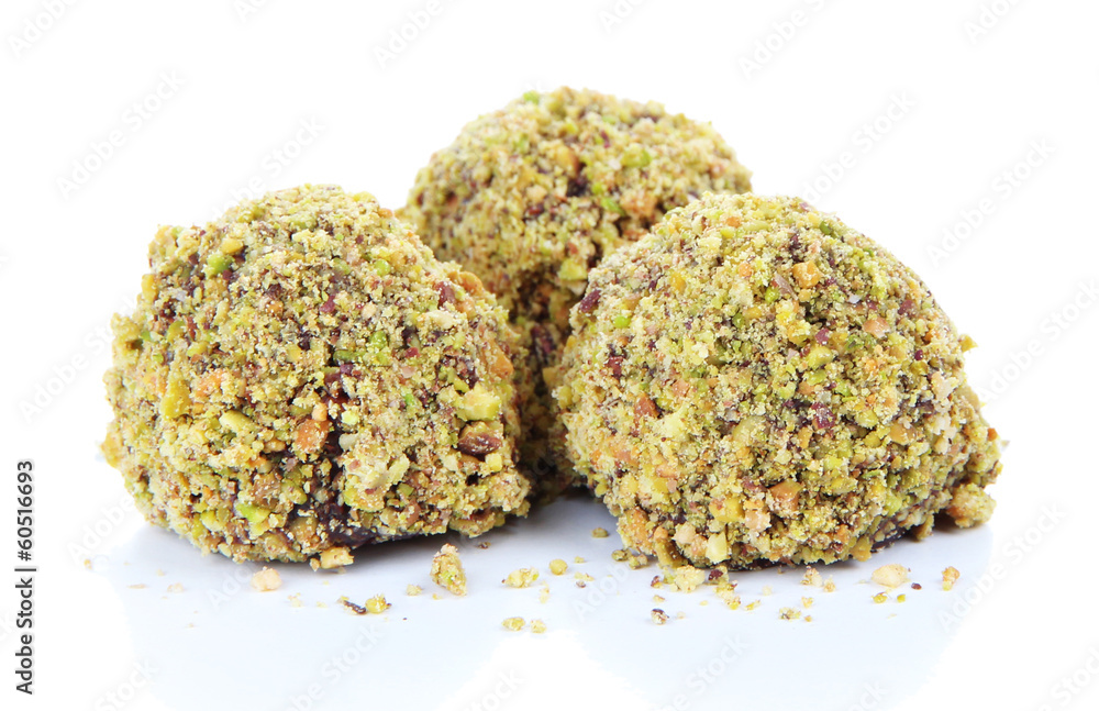 Chocolate candies with chopped pistachios, isolated on white