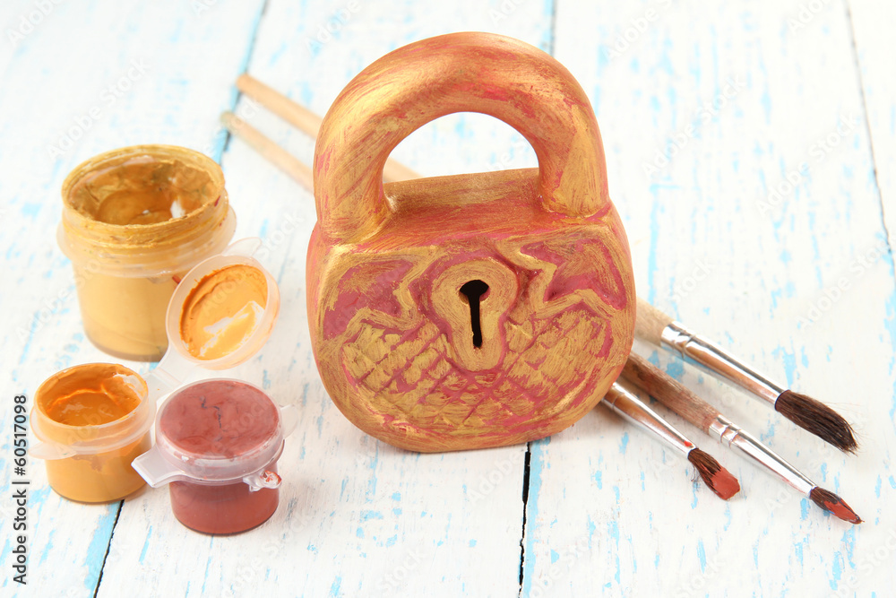 Hand made ceramic castle and color paints on wooden table