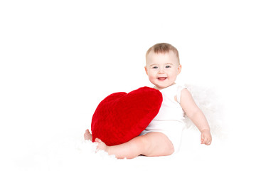 Portrait of little valentine angel with red soft heart