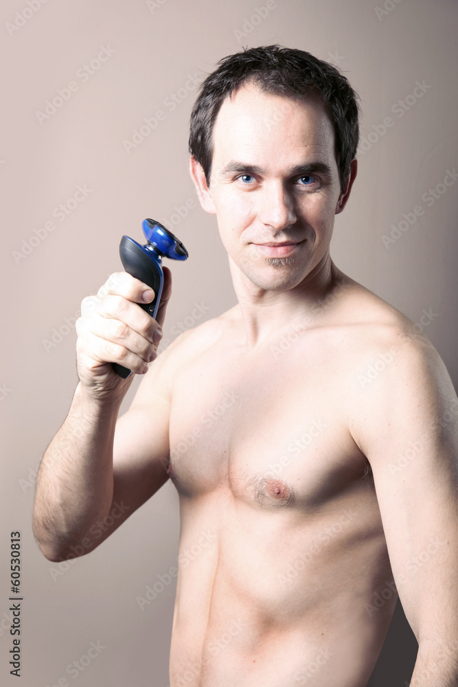 handsome man with electric shaver - obrazy, fototapety, plakaty 