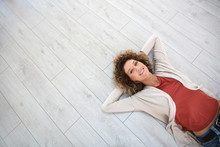 Woman Laying On Wooden Modern Flooring