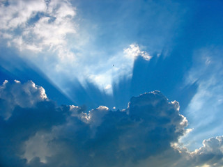 Wall Mural - Blue sky with sun rays through the clouds