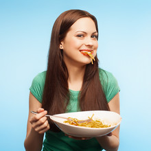 Girl Eats Pasta. Isolated