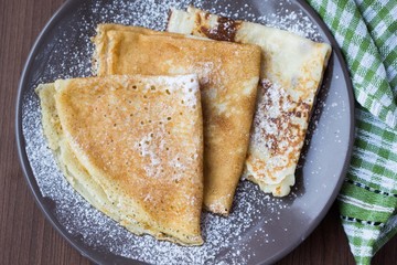 Wall Mural - Thin sweet pancakes with powdered sugar for Breakfast