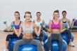 © WavebreakMediaMicro - Women exercising with dumbbells on fitness balls