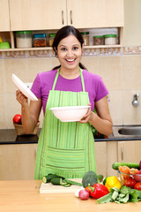 Excited young woman in kitchen