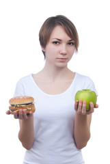 Girl makes choice between apple and hamburger