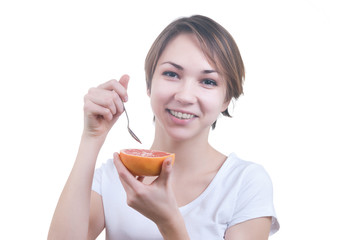 Wall Mural - Girl eating grapefruit by the spoon