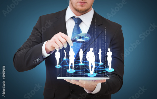 Fotografie, Tablou businessman hand holding magnifier over tablet pc