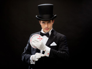 magician showing trick with playing cards