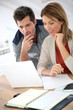 © goodluz - Couple at home checking accounts on internet