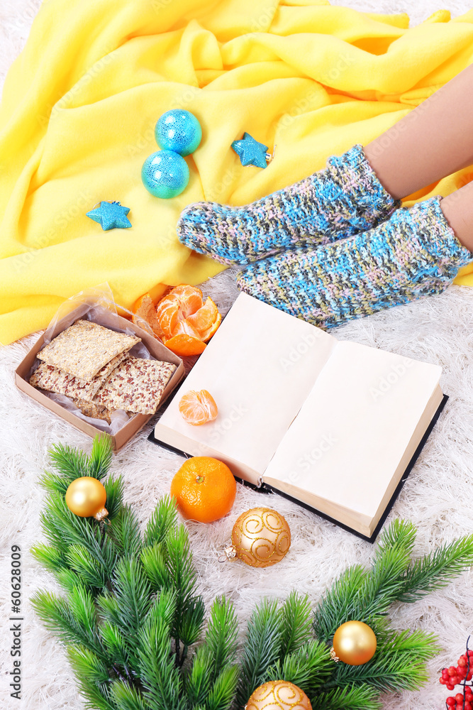 Composition with warm plaid, book,k and female legs,