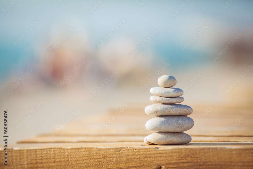 zen stones jy wooden banch on the beach near sea. Outdoor - obrazy, fototapety, plakaty 