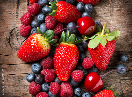 Fototapeta do kuchni Berries on Wooden Background. Spring Organic Berry