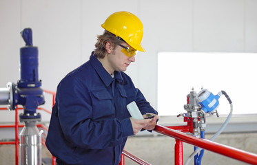 Wall Mural - Engineer controls devices in a power plant