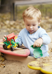 Boy playing with toy outdoor.